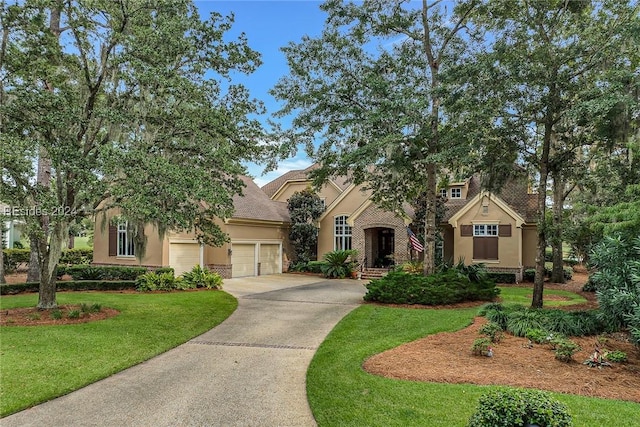 view of front of property featuring a garage and a front yard