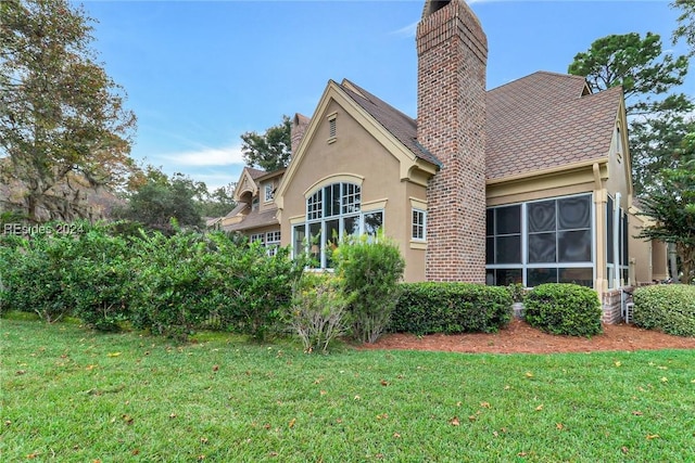 back of house featuring a yard