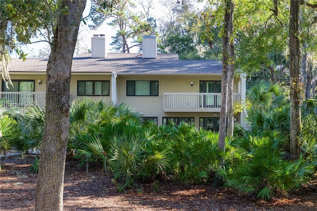 rear view of property featuring a balcony