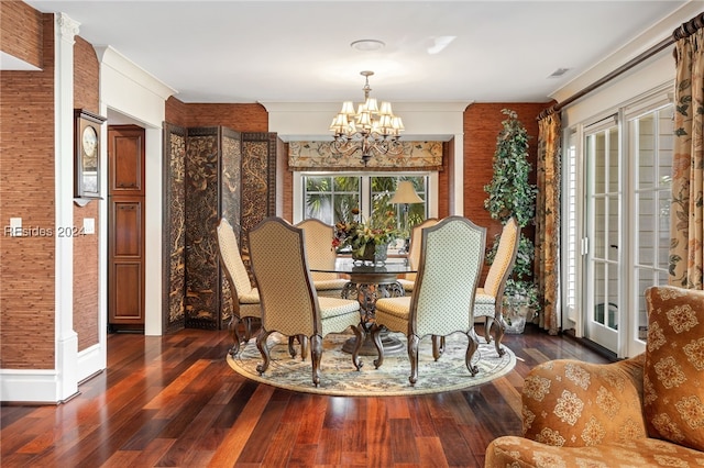 dining space with dark hardwood / wood-style flooring and a chandelier