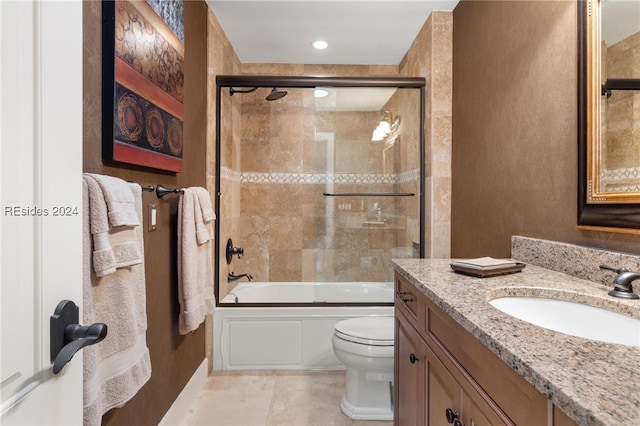 full bathroom featuring toilet, vanity, and shower / bath combination with glass door