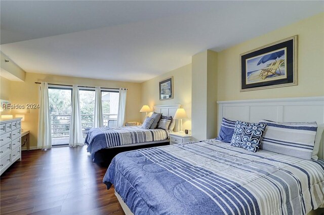 bedroom with dark hardwood / wood-style flooring