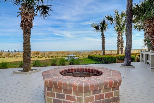 exterior space featuring a wooden deck and a fire pit