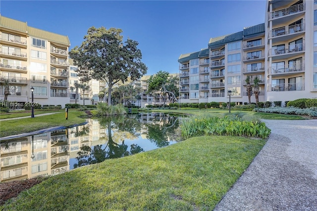 view of property's community featuring a water view and a lawn