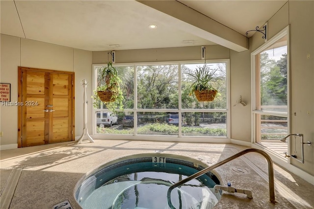 view of swimming pool with an indoor hot tub