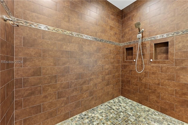 bathroom with a tile shower