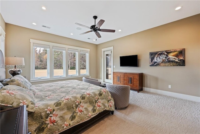 bedroom with ceiling fan and light carpet