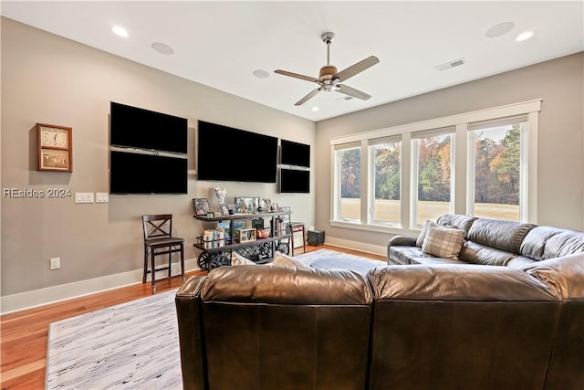 living room with ceiling fan and light wood-type flooring