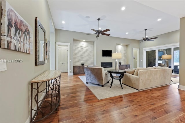 living room featuring ceiling fan and wood-type flooring