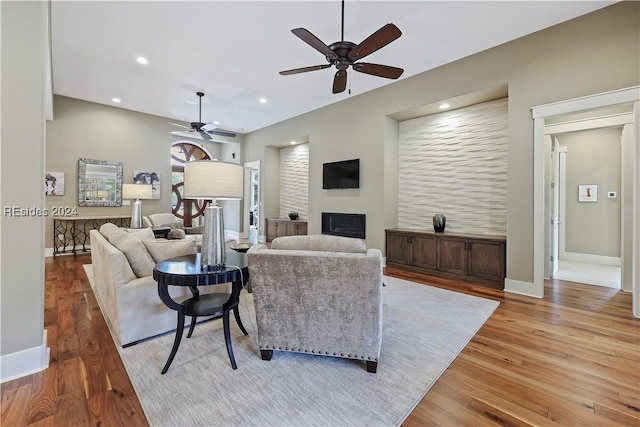 living room featuring ceiling fan and light wood-type flooring