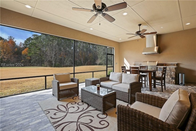 sunroom featuring ceiling fan