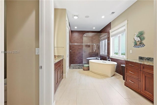 bathroom with vanity, independent shower and bath, and tile patterned flooring