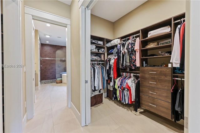 spacious closet featuring light tile patterned floors