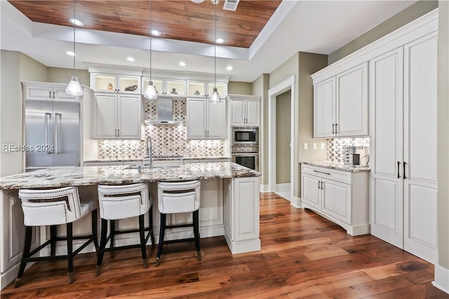 kitchen with built in appliances, white cabinetry, and wooden ceiling