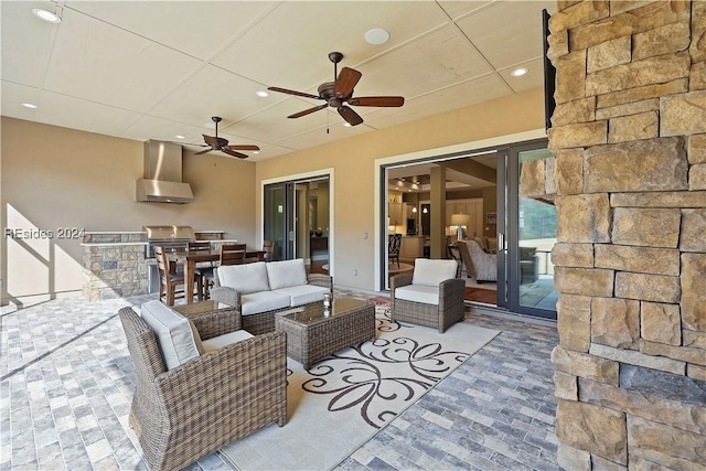 view of patio / terrace featuring outdoor lounge area, ceiling fan, and an outdoor kitchen