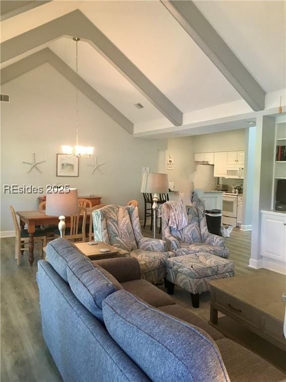 living room with hardwood / wood-style flooring, a chandelier, and vaulted ceiling with beams