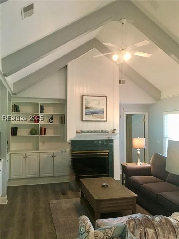 living room featuring dark hardwood / wood-style floors and vaulted ceiling with beams