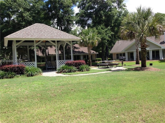 surrounding community with a gazebo and a yard