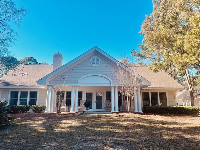 back of property featuring french doors and a yard