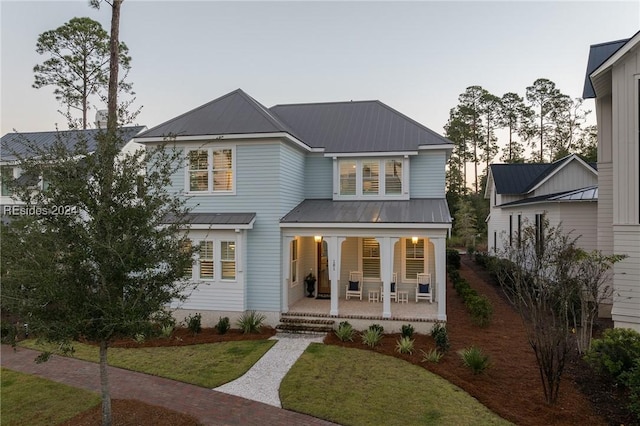 view of front of home with a lawn and covered porch