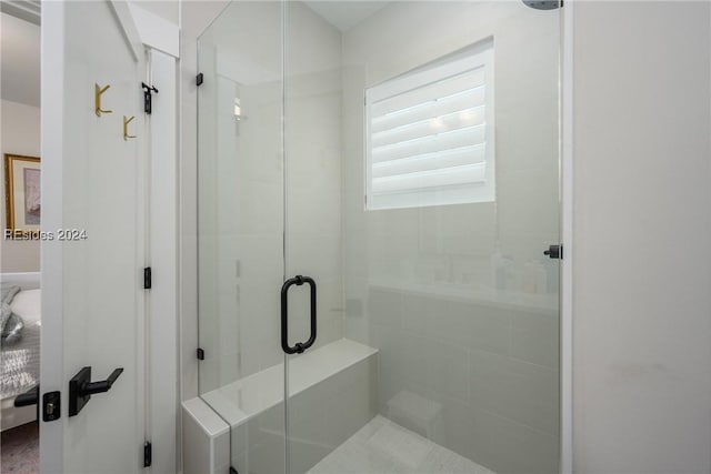 bathroom with a shower with shower door