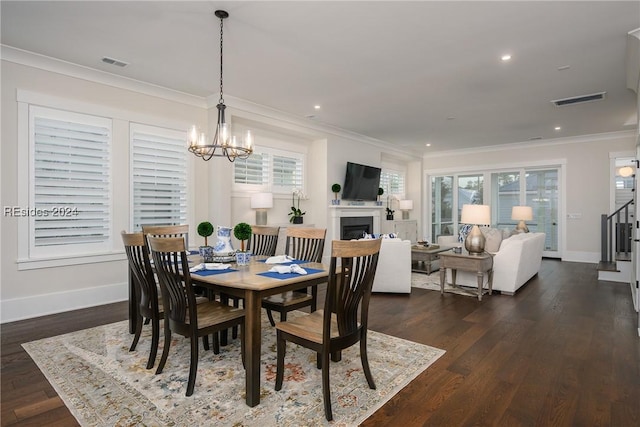 dining room with ornamental molding, dark hardwood / wood-style floors, and a notable chandelier