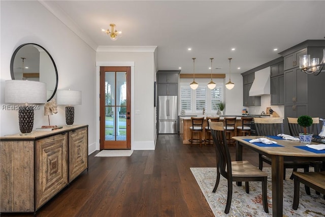 dining area with crown molding, dark wood-type flooring, and a chandelier