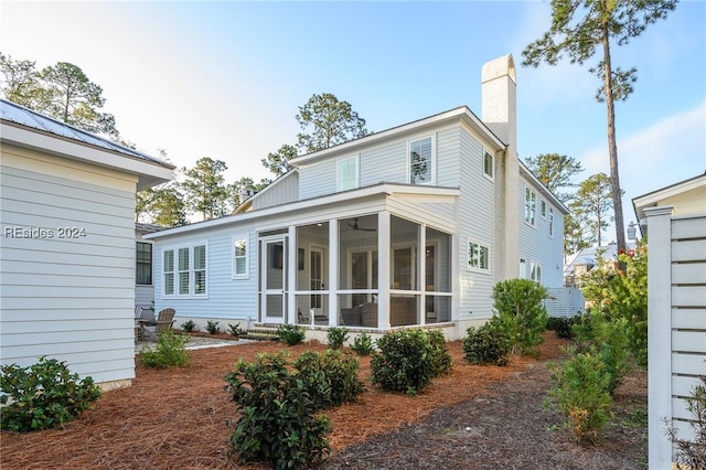 rear view of property with a sunroom