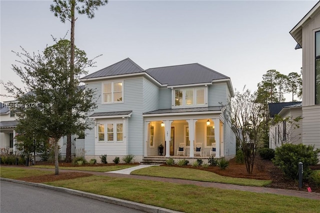 view of front facade featuring a front yard and covered porch