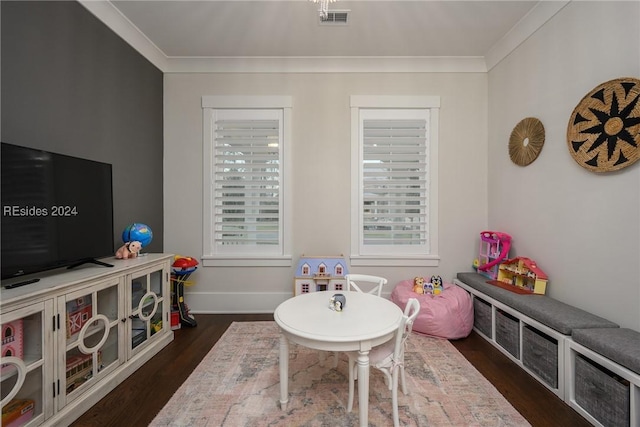 playroom featuring dark wood-type flooring and ornamental molding