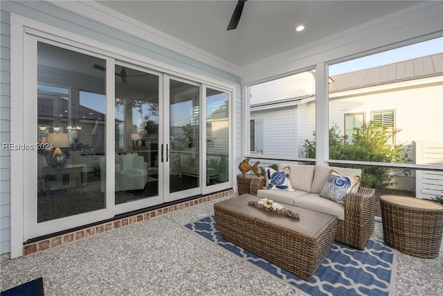 sunroom / solarium featuring ceiling fan