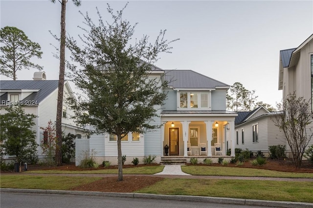 view of front of home with a porch and a front yard