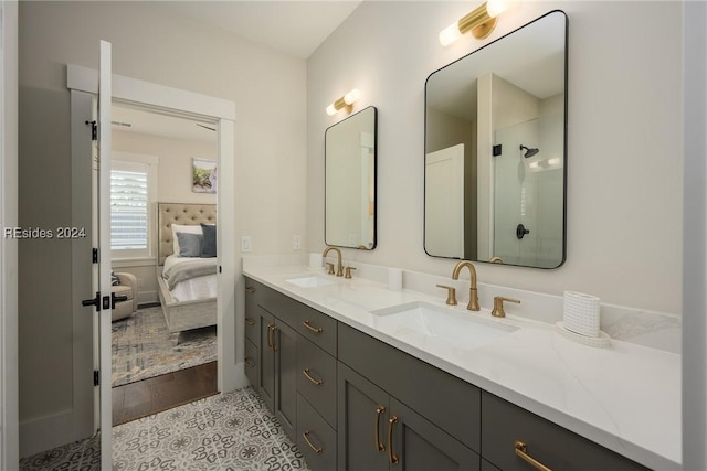 bathroom featuring tile patterned flooring, vanity, and a shower