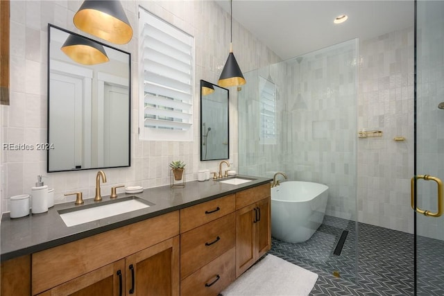 bathroom featuring tile patterned floors, vanity, separate shower and tub, and tile walls