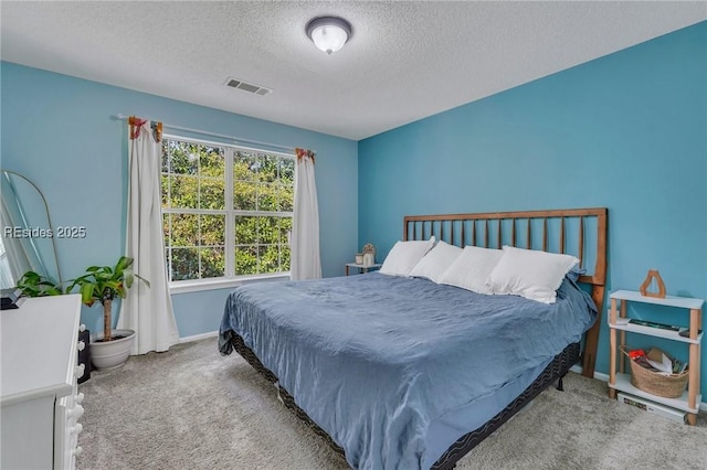 bedroom with carpet and a textured ceiling