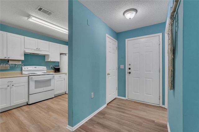 kitchen featuring white cabinets, light hardwood / wood-style floors, a textured ceiling, and electric range