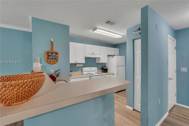 kitchen featuring white cabinetry, light wood-type flooring, a textured ceiling, and white appliances