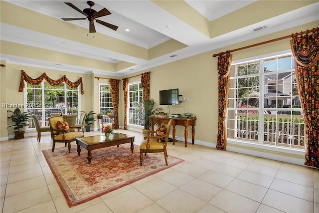 tiled living room with a tray ceiling, ornamental molding, and ceiling fan