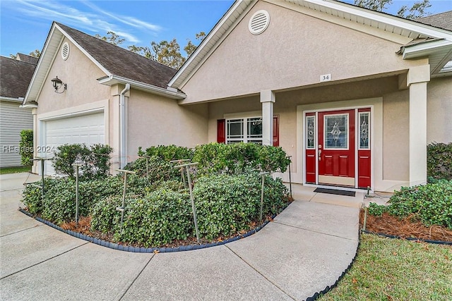 doorway to property with a garage