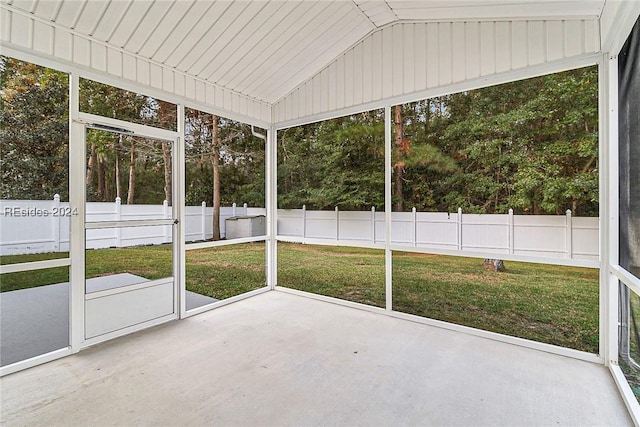 unfurnished sunroom featuring lofted ceiling