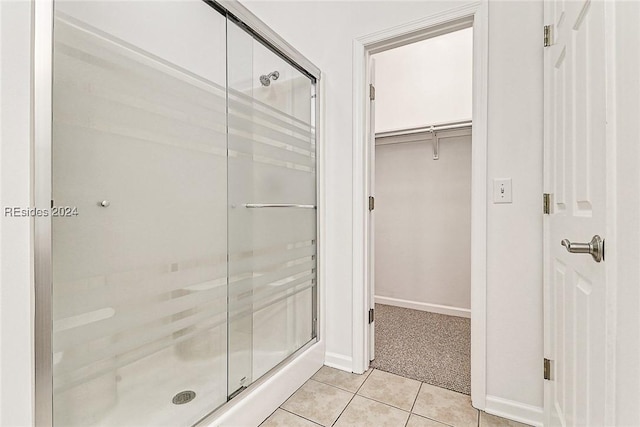 bathroom featuring tile patterned flooring and walk in shower