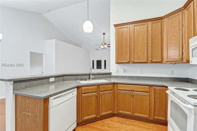 kitchen featuring lofted ceiling, sink, white appliances, ceiling fan, and light hardwood / wood-style floors