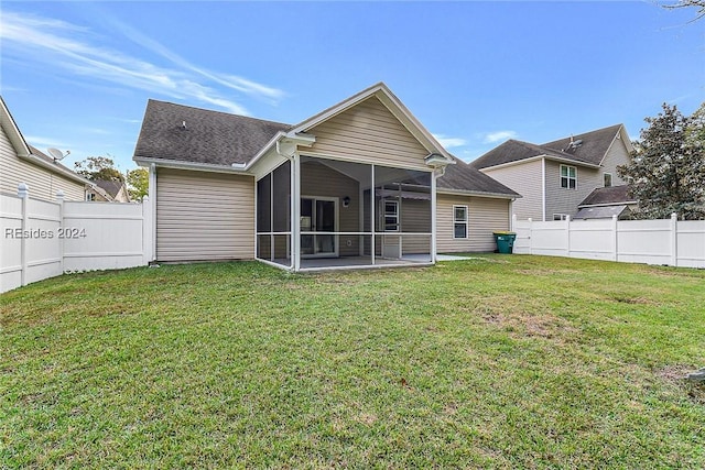 back of property with a patio, a sunroom, and a lawn