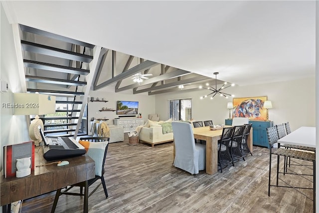 dining room with lofted ceiling with beams, ceiling fan with notable chandelier, and hardwood / wood-style floors