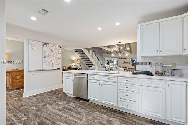 kitchen with sink, dishwasher, pendant lighting, decorative backsplash, and white cabinets