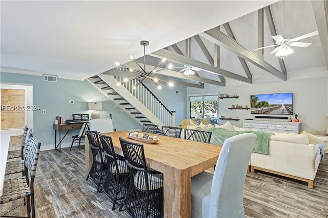 dining area with dark hardwood / wood-style floors, ceiling fan with notable chandelier, and vaulted ceiling with beams