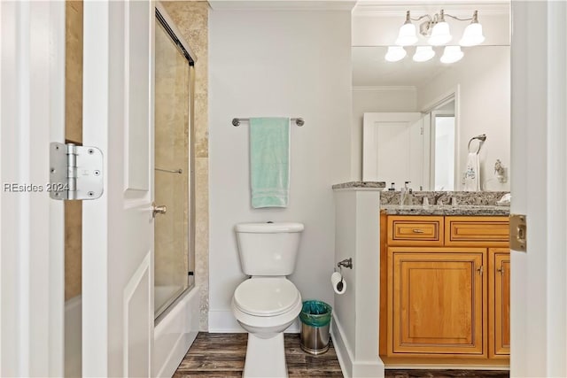 full bathroom featuring toilet, crown molding, shower / bath combination with glass door, vanity, and hardwood / wood-style floors