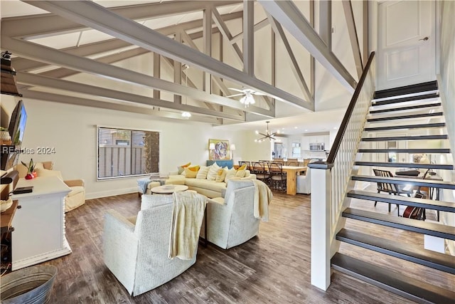 living room with beam ceiling, dark hardwood / wood-style floors, a notable chandelier, and high vaulted ceiling