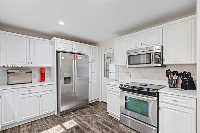 kitchen featuring appliances with stainless steel finishes, backsplash, white cabinets, and dark hardwood / wood-style flooring