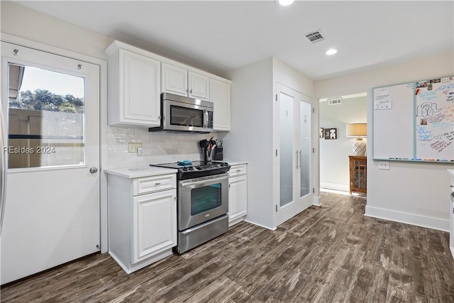 kitchen featuring white cabinetry, backsplash, dark hardwood / wood-style flooring, and stainless steel appliances